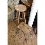 A 19th Century oak milking stool and a vintage beech stool