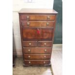 A Regency style mahogany chest of drawers with fall to centre