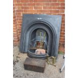 An Edwardian cast iron fire place and brass irons and dogs