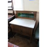 An Edwardian oak marble top washstand