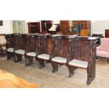 A set of six mid 19th Century oak Gothic Revival inter connecting choir stalls.