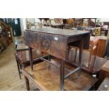 An early 19th Century oak drop leaf table