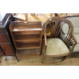 A small stained bookcase with walnut armchair