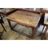 An early 19th Century oak stretcher dining table