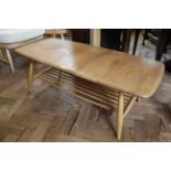 A mid Century blonde teak Ercol coffee table with under tier