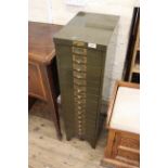 An early 20th Century painted metal bank of drawers
