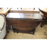 An early 19th Century oak gate leg drop leaf table