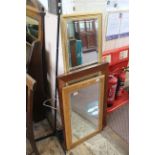 Three rectangular wooden framed mirrors of various sizes