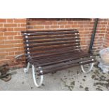 A teak and white iron garden bench of small proportions