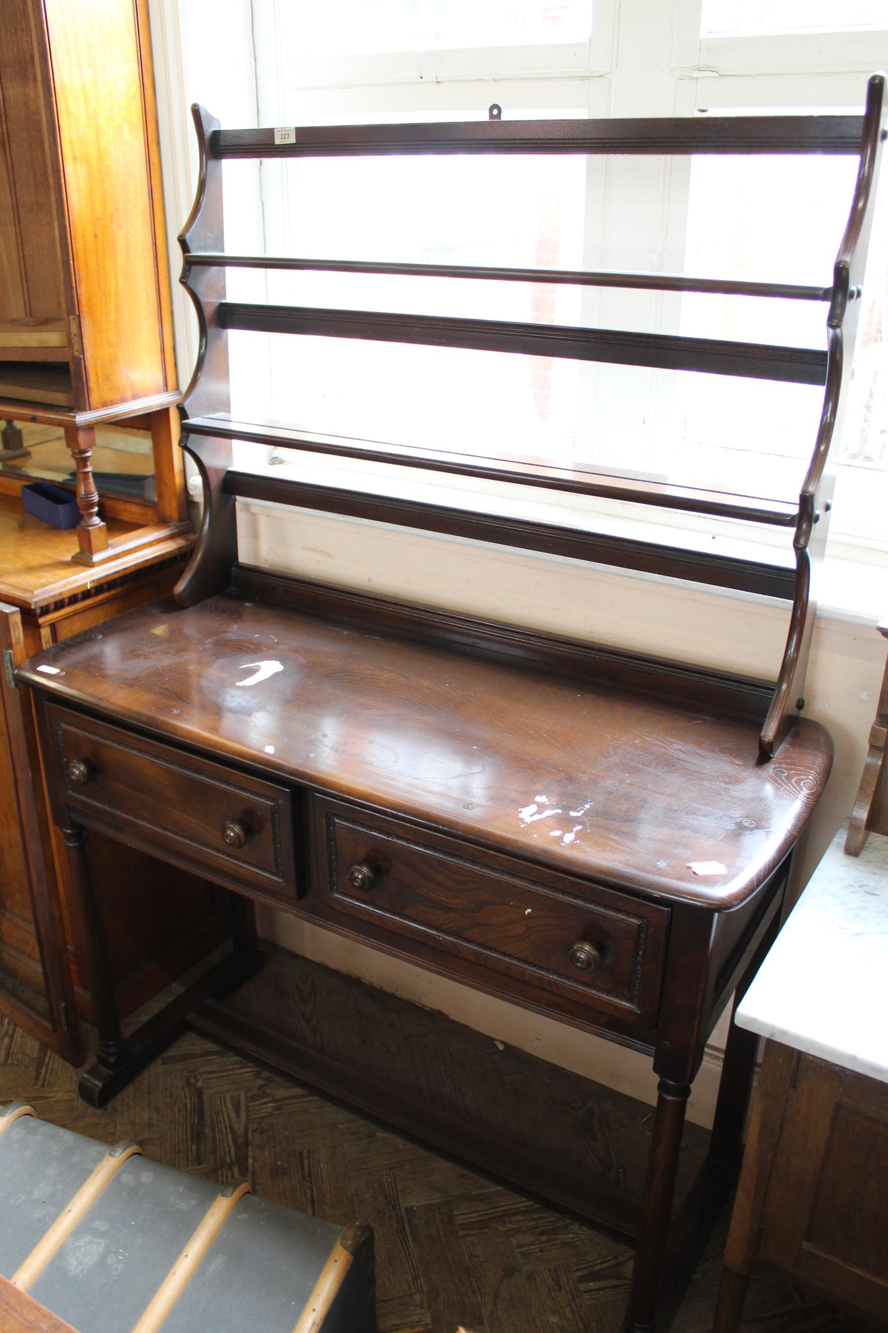 A mid 20th Century stained teak dresser on stretcher base