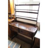 A mid 20th Century stained teak dresser on stretcher base