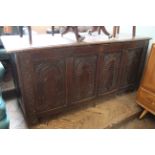 An 18th Century carved oak panelled coffer