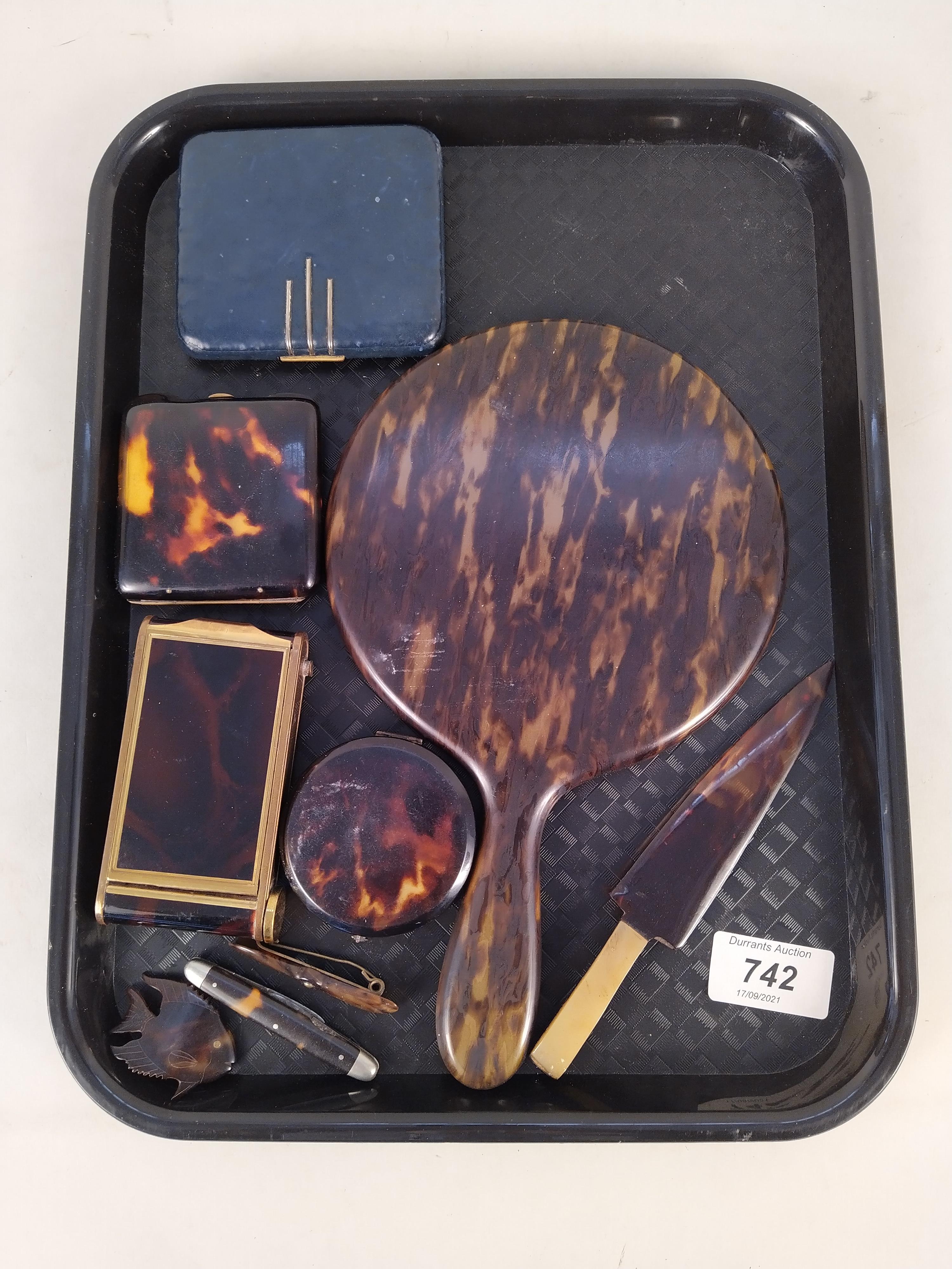 A selection of faux tortoiseshell items including hand mirror, powder compacts, jewellery,