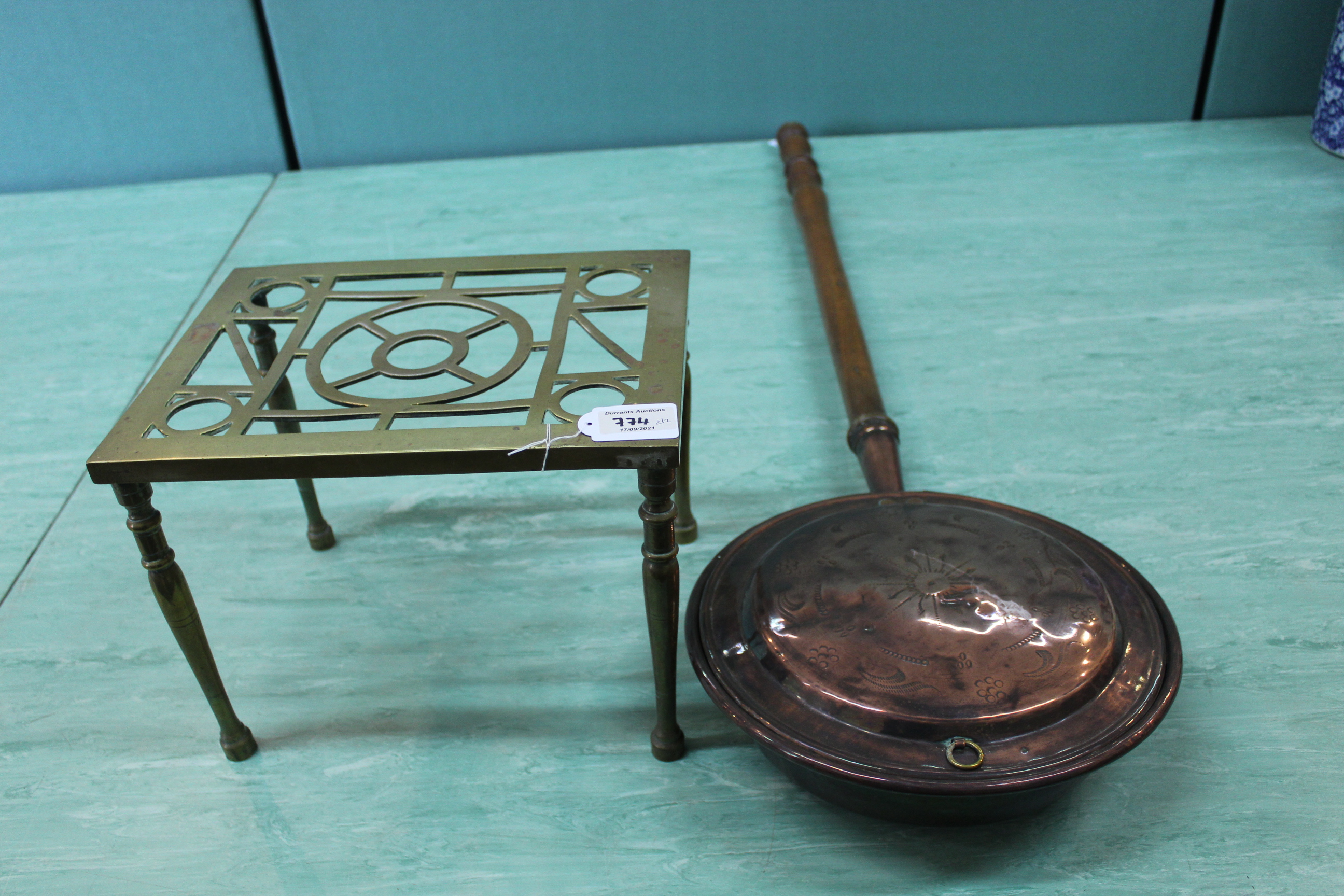 A vintage brass footman plus a copper bed warming pan