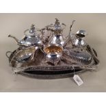 Two large silver plated gallery trays plus a four piece tea set and lidded butter dish