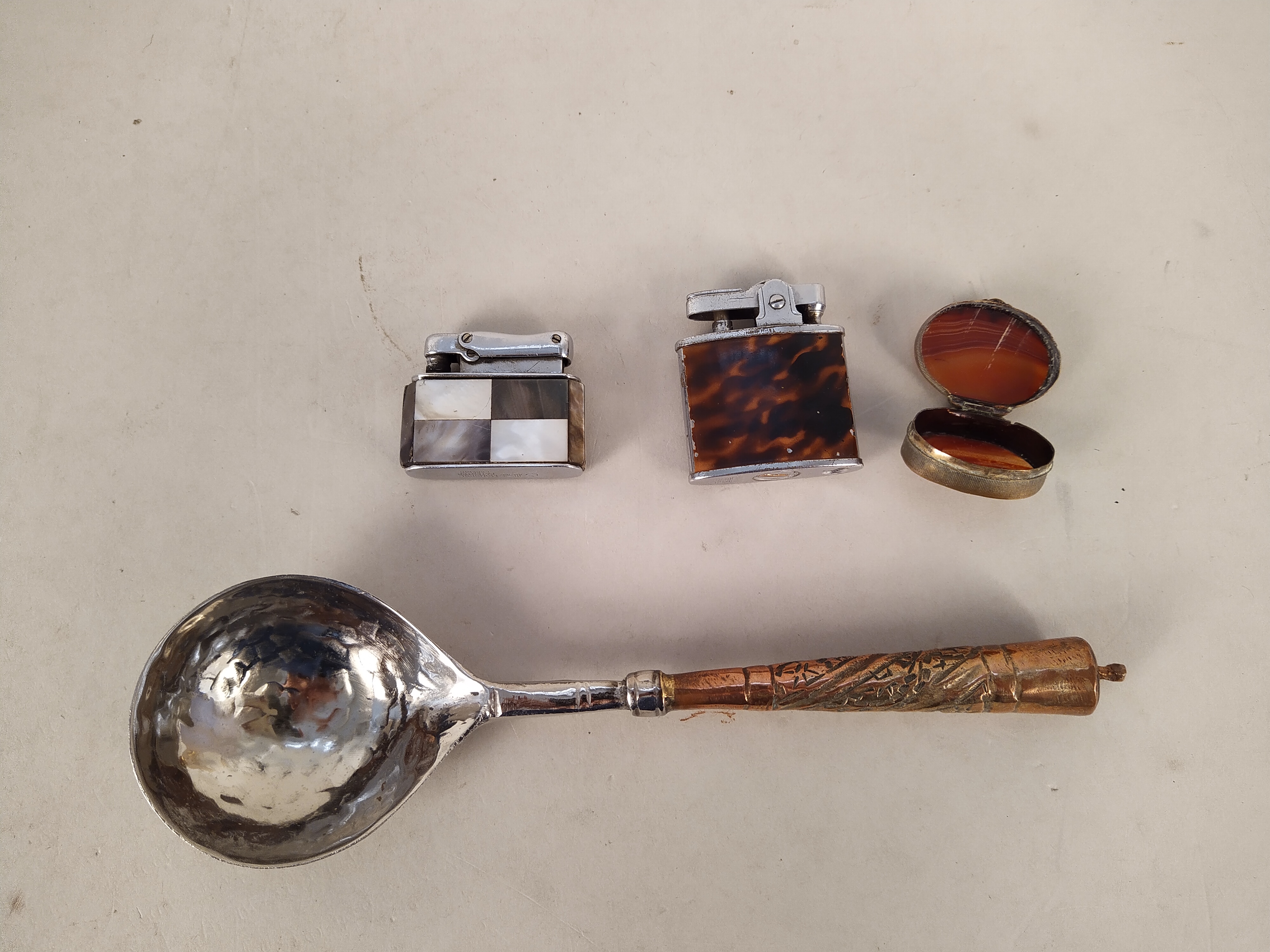 A white metal and copper handled spoon with hand beaten bowl, Colibri and Auer lighters, - Image 2 of 3