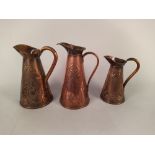 Three decorative Art Nouveau period copper jugs, the tallest marked JS&S (Joseph Sankey & Sons),