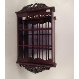 A pair of small mahogany hanging shelves with carved pierced cresting