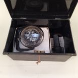 A tin box containing three boat compasses including a Heath-Marine 'Bosun' compass in original