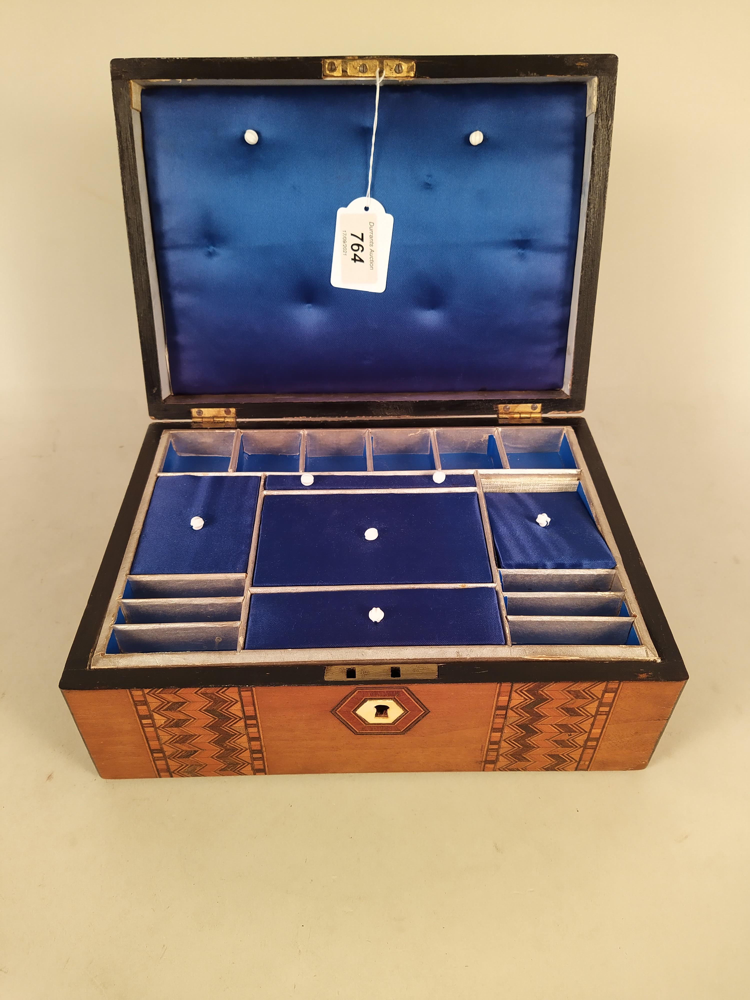 A marquetry inlaid sewing box, the interior is blue velvet and fitted with lift out tray,