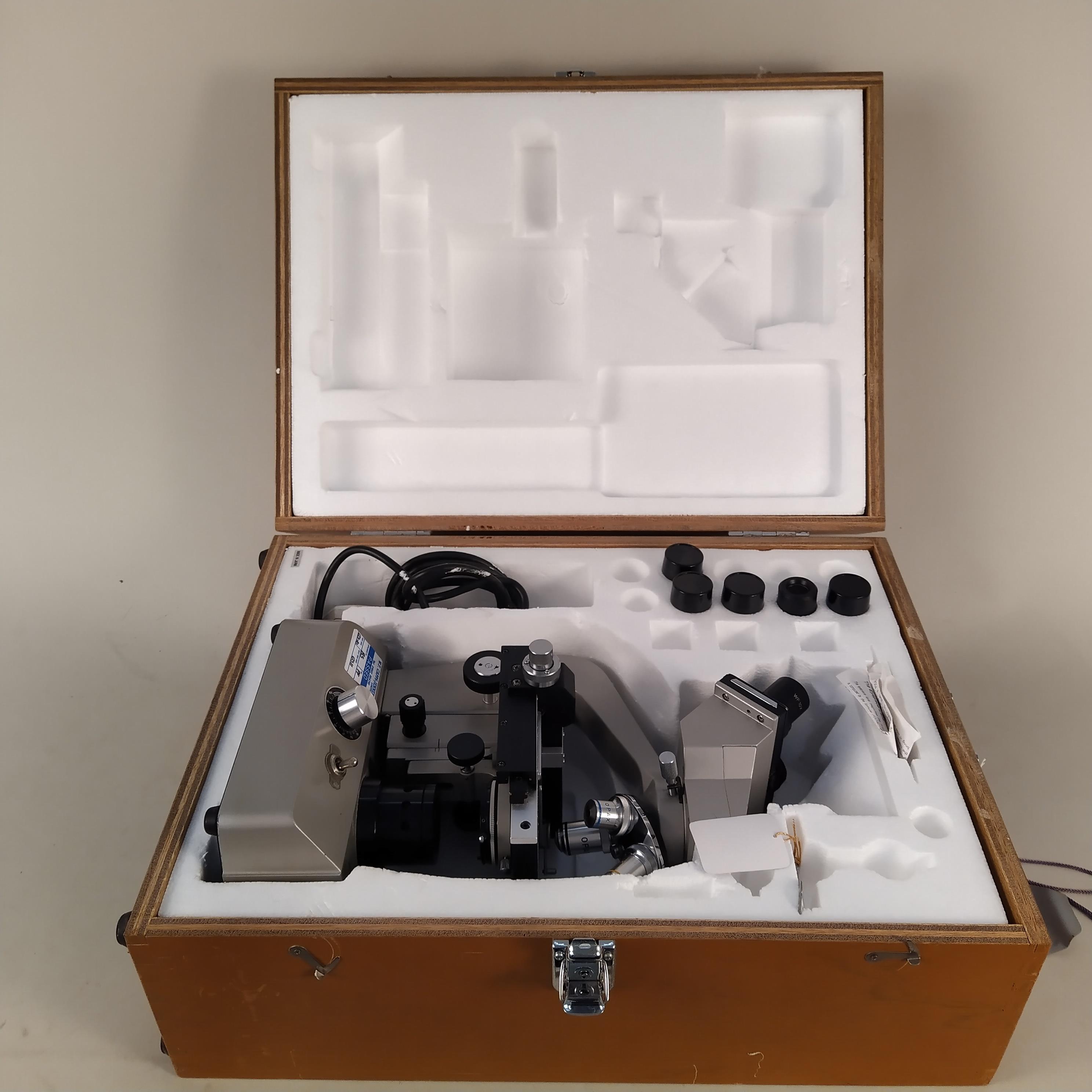 A cased Opax binocular electric microscope