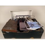 A box of vintage film camera developing equipment including ceramic trays