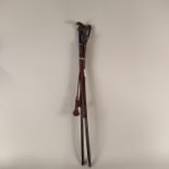 Three vintage red leather covered riding crops, one with Egyptian head handle,
