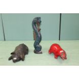 A collection of large animal ornaments including a red glazed badger, pottery pig,