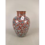An antique hand painted large vase with terracotta body and a tin glaze type over decoration,