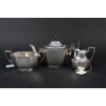 A silver three piece tea set with presentation inscription to teapot,