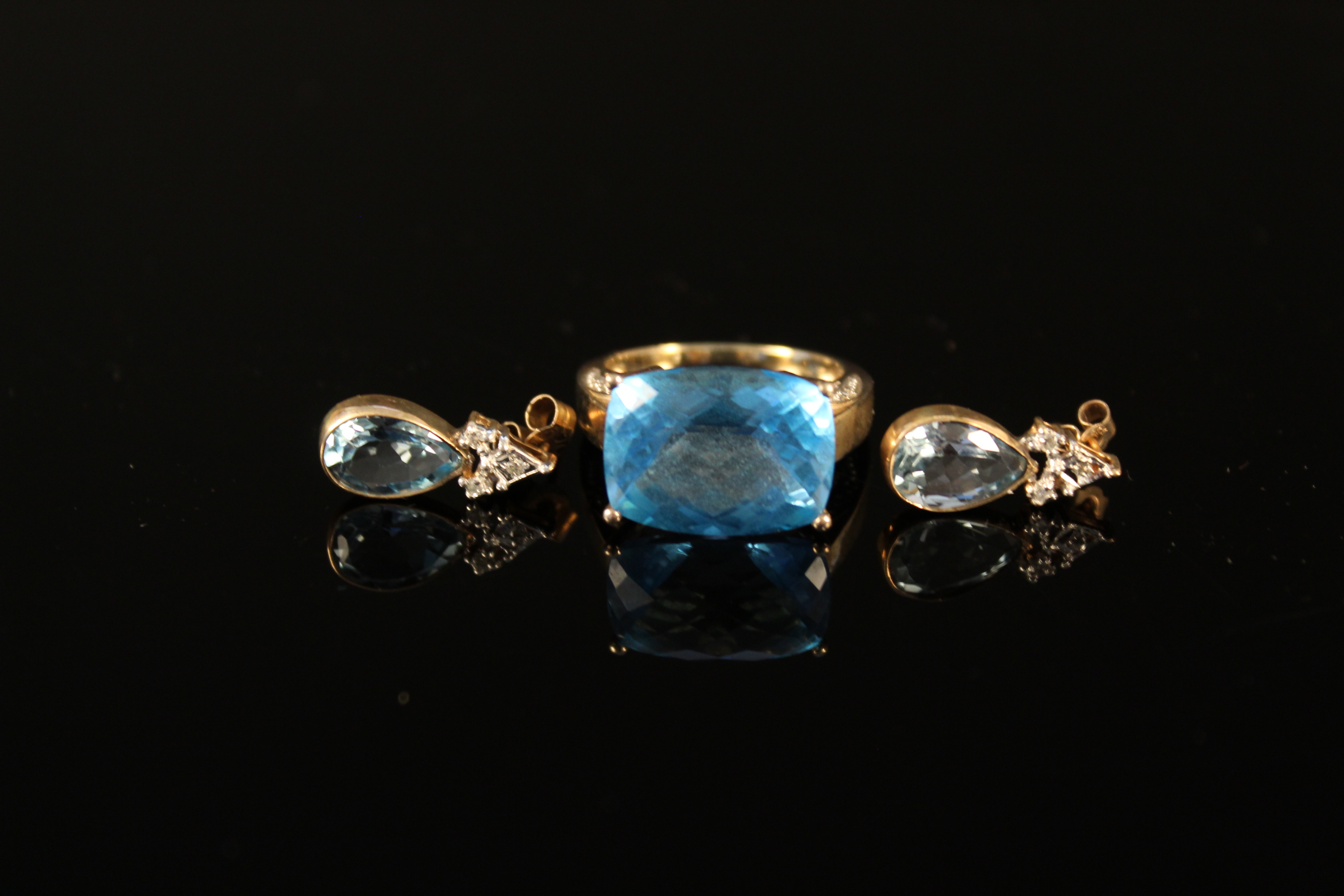 A 9ct gold multi faceted blue topaz set ring with white gold decoration to setting plus a pair of