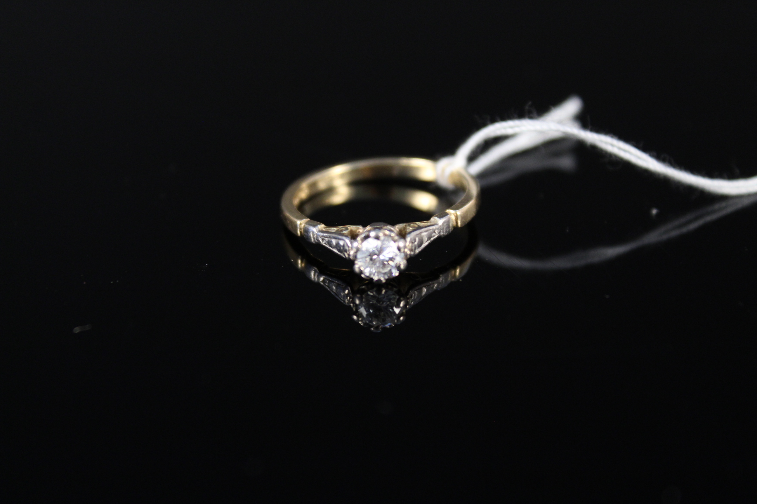 An 18ct gold solitaire diamond ring in raised claw setting, size M, weight approx 2.