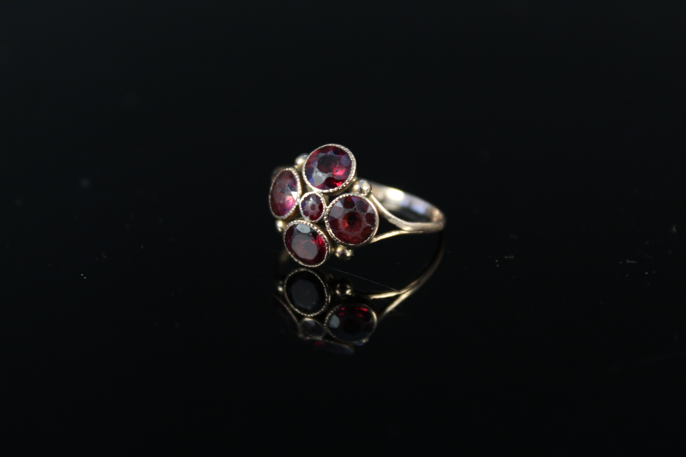 A 9ct gold garnet set ring (band misshapen), weight approx 1.