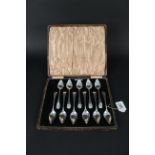 Eleven (of twelve) silver grapefruit spoons in original case, each spoon engraved with initial,