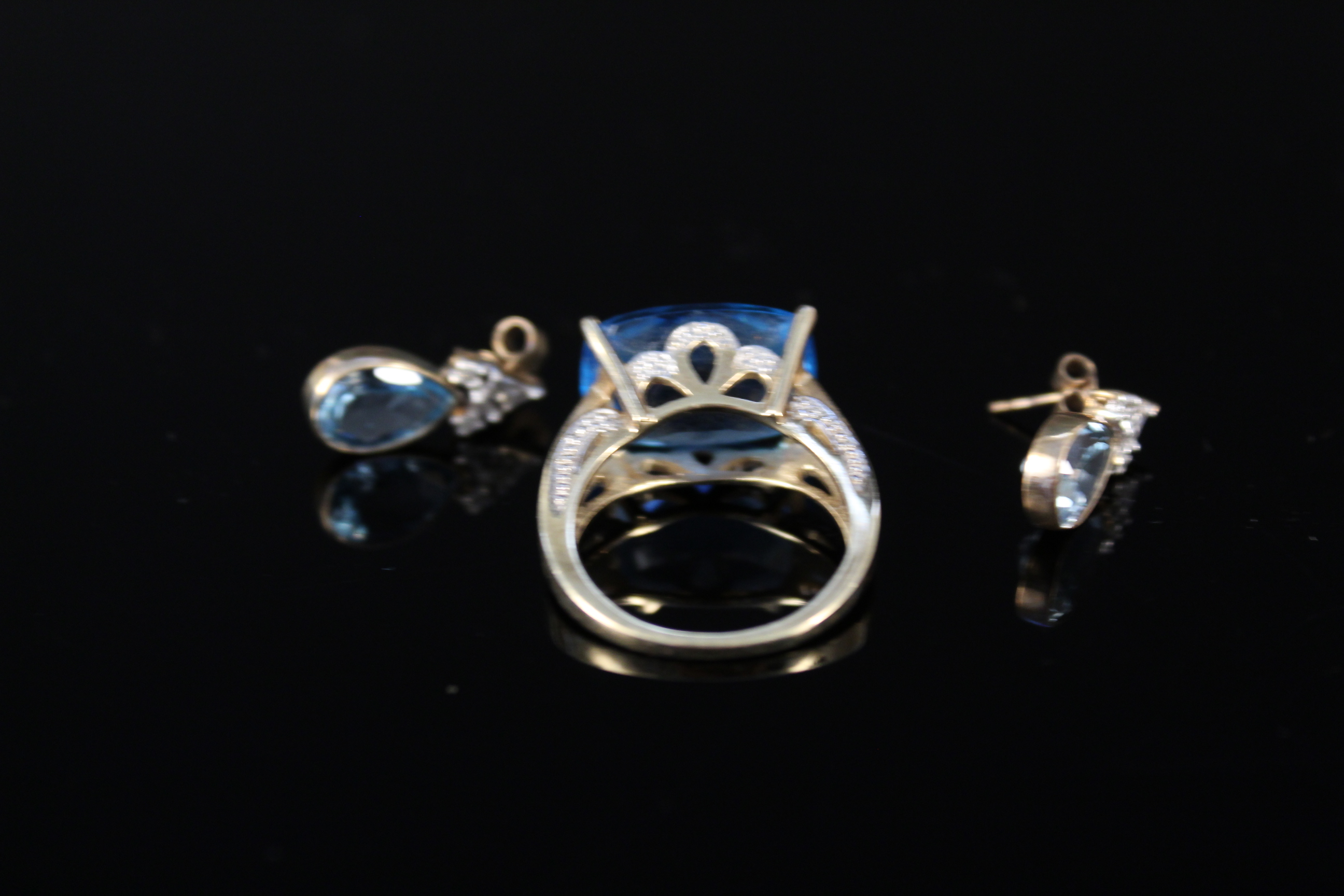 A 9ct gold multi faceted blue topaz set ring with white gold decoration to setting plus a pair of - Image 2 of 3