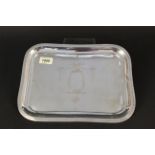 A rectangular silver dressing table tray with simple engraved border and engraved floral and swag