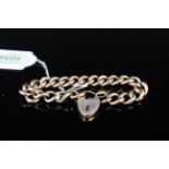 A 9ct gold curb link bracelet (as found) with heart shaped padlock clasp,