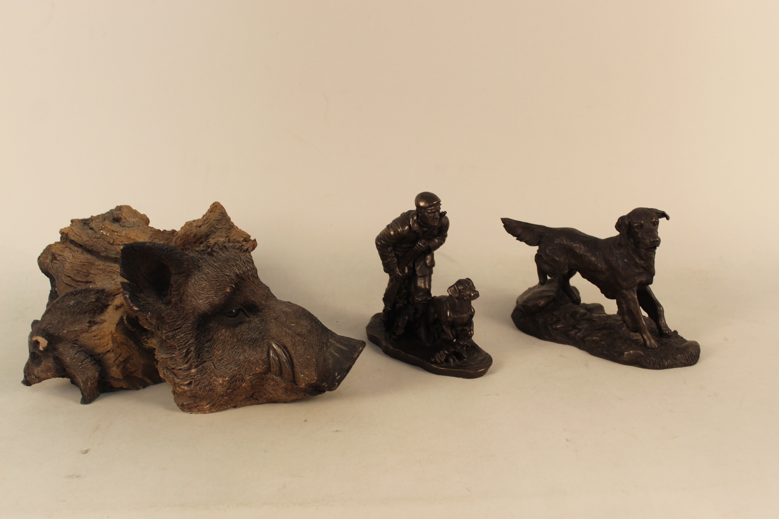 An interesting cast resin boars head resembling carved wood,