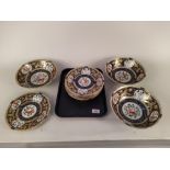 Eight hand painted plates in two designs,