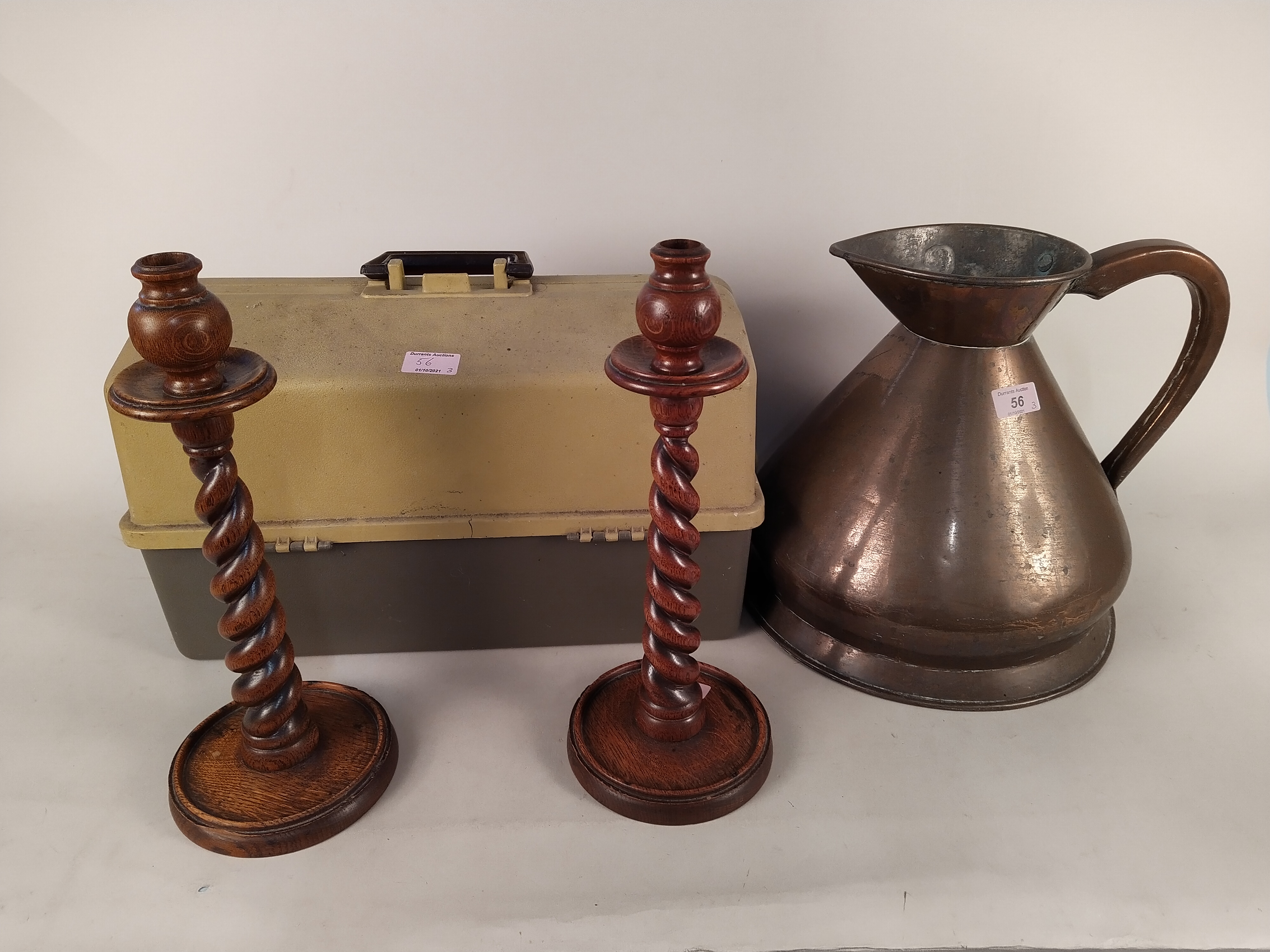 A pair of 1920's oak barley twist candlesticks, a copper jug stamped "2 gallons V.R.