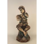A late 18th Century/early 19th Century carved wooden figure of a youth clutching a sheaf of corn,