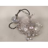 A cut glass hanging ceiling light with facet cut drops