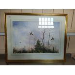 A framed unsigned watercolour of pheasants in flight in winter,
