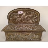 A large Dutch hanging brass candle box with raised back and embossed with a Coat of Arms,