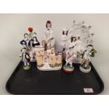 Four Staffordshire pottery figures and three German porcelain figures
