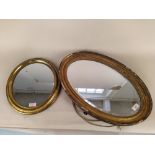 An early 19th Century oval gilt wood wall mirror with bevelled glass plate and a Victorian oval