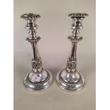 A pair of early 20th Century Rococo style silver plate on copper candlesticks,