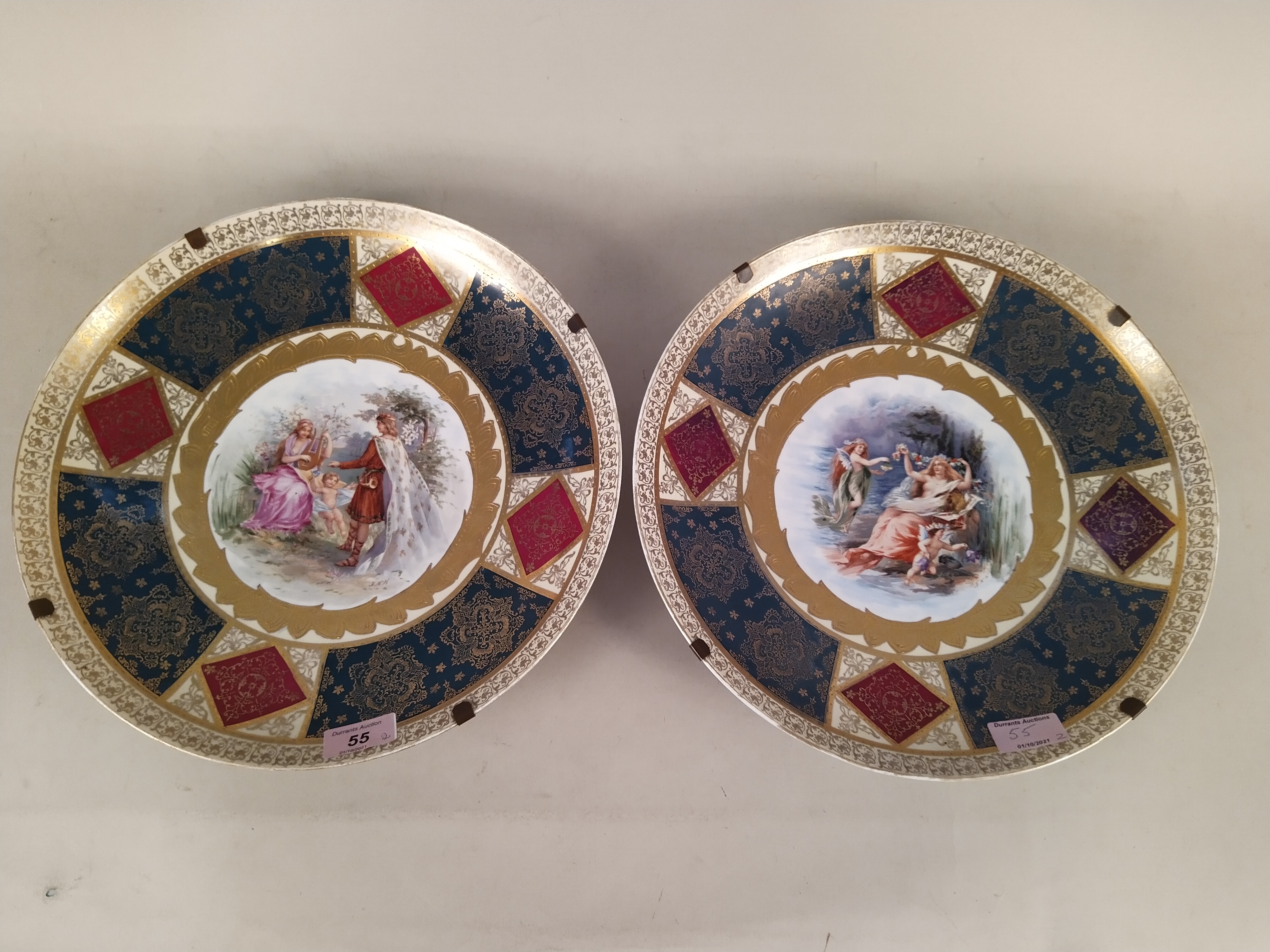 A pair of late 19th Century Schierholz porcelain dishes heavily gilded with central hand painted