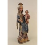 A 19th Century continental painted wooden figure of a Madonna and child,