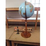 A large textured surface globe on stand by "Replogle Globes Inc",